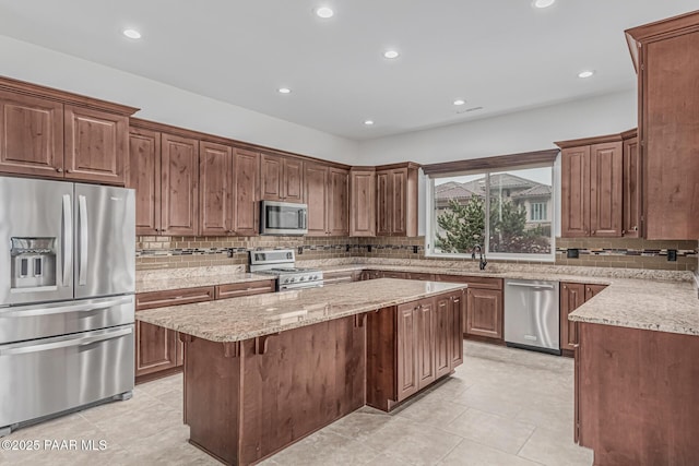 893 Canyon Breeze Ct, Prescott, AZ 86303 - kitchen featuring stainless steel appliances, a kitchen island, decorative backsplash, light stone counters, and recessed lighting