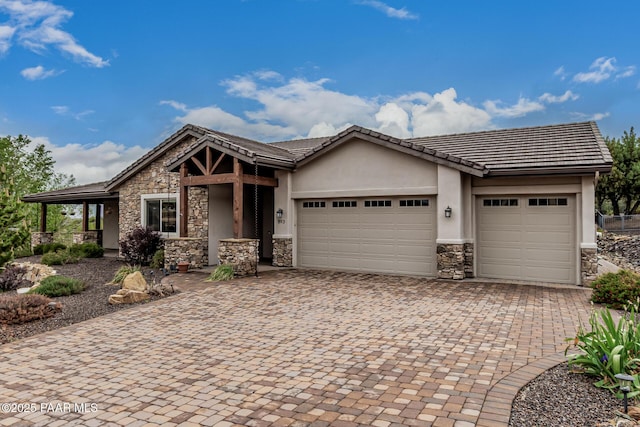 893 Canyon Breeze Ct, Prescott, AZ 86303 - view of front of home with stone siding, an attached garage, decorative driveway, stucco siding, and a tile roof