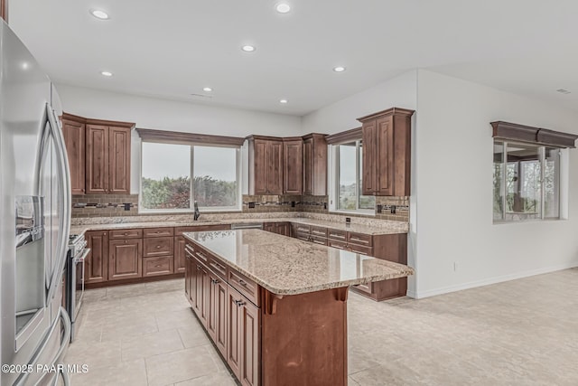 893 Canyon Breeze Ct, Prescott, AZ 86303 - kitchen featuring appliances with stainless steel finishes, a center island, tasteful backsplash, recessed lighting, and light stone counters