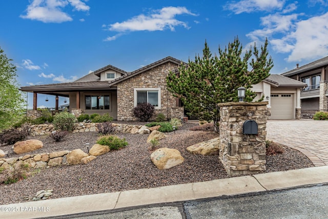 893 Canyon Breeze Ct, Prescott, AZ 86303 - view of front of property with stone siding, a garage, decorative driveway, a tiled roof, and stucco siding