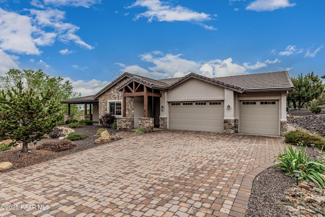 893 Canyon Breeze Ct, Prescott, AZ 86303 - view of front of home featuring stone siding, a garage, stucco siding, driveway, and a tile roof