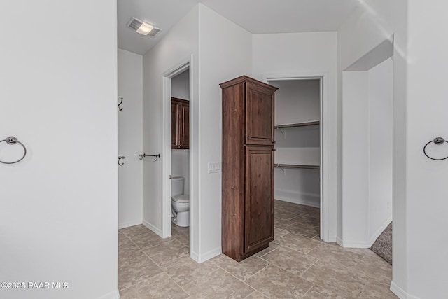 893 Canyon Breeze Ct, Prescott, AZ 86303 - bathroom featuring toilet, baseboards, and a walk in closet