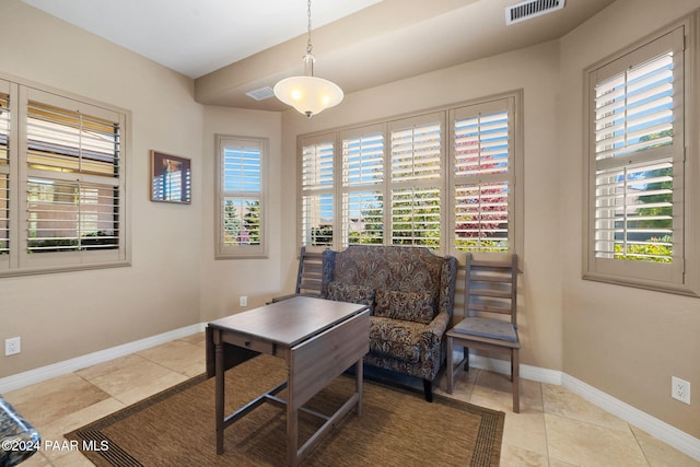 living area with light tile patterned floors and a healthy amount of sunlight