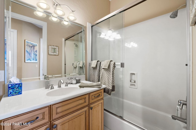 bathroom with vanity, bath / shower combo with glass door, and a notable chandelier