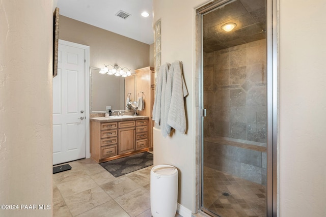 bathroom featuring vanity and an enclosed shower