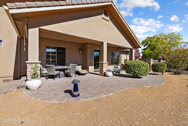 back of property featuring a patio area