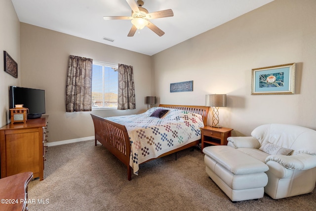 carpeted bedroom featuring ceiling fan and vaulted ceiling