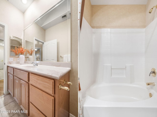 bathroom with tile patterned flooring, vanity, and washtub / shower combination