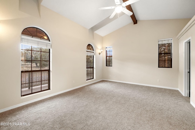 spare room with lofted ceiling with beams, ceiling fan, and carpet