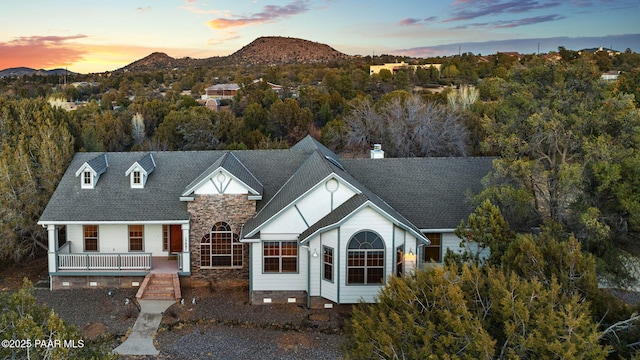 view of front of house with a mountain view and a porch