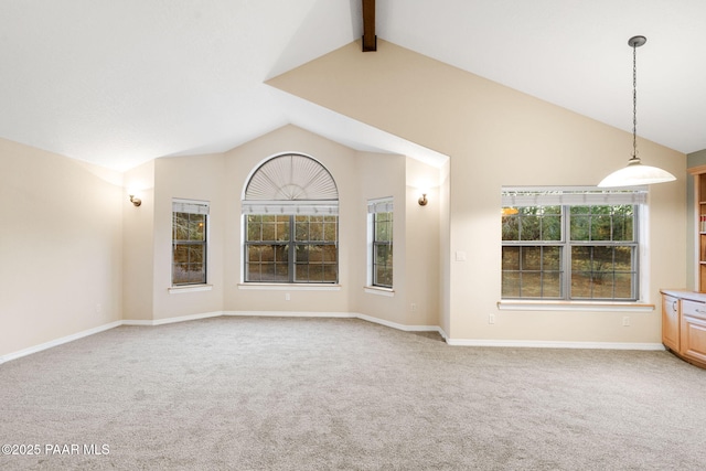 unfurnished living room with carpet and vaulted ceiling with beams