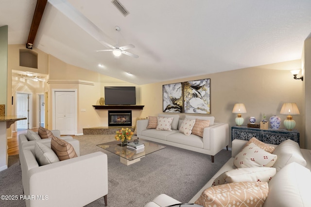 carpeted living room featuring ceiling fan and lofted ceiling with beams