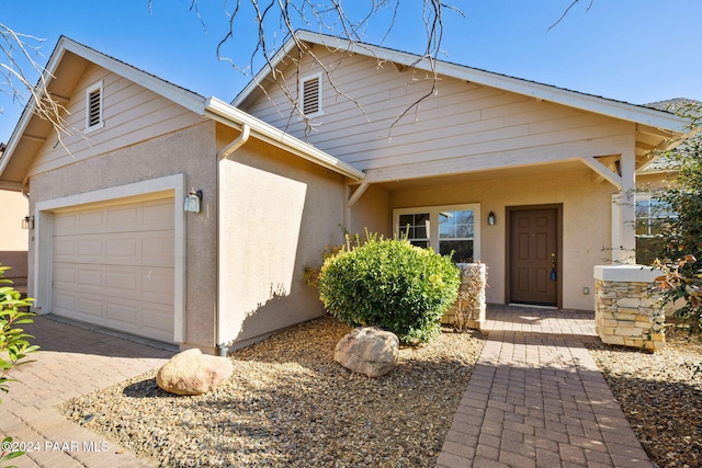 view of front of home featuring a porch and a garage