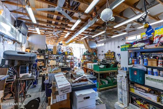 miscellaneous room with a workshop area and concrete floors