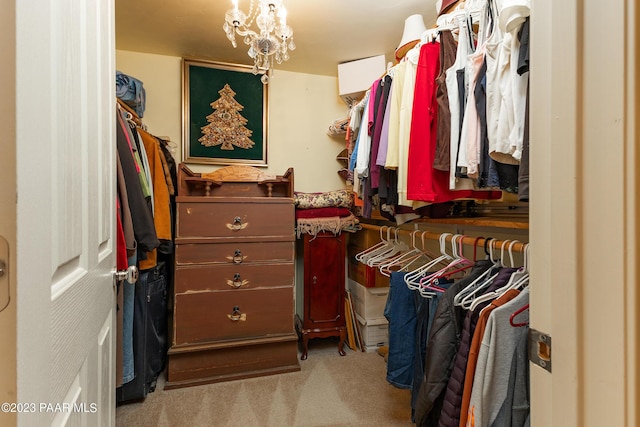 walk in closet featuring light carpet