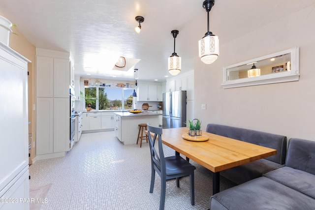 dining area featuring breakfast area and sink