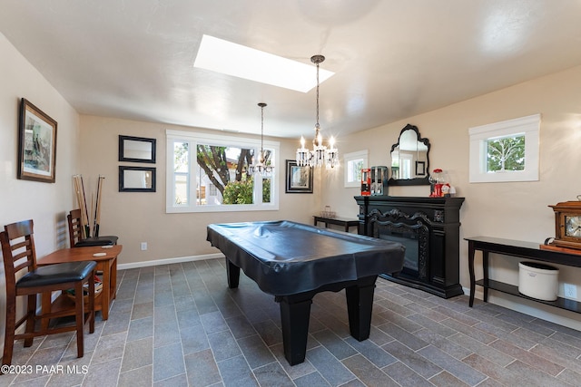 game room featuring plenty of natural light, a chandelier, and pool table