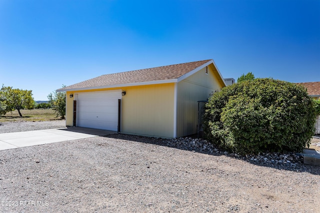 view of property exterior featuring a garage and an outbuilding