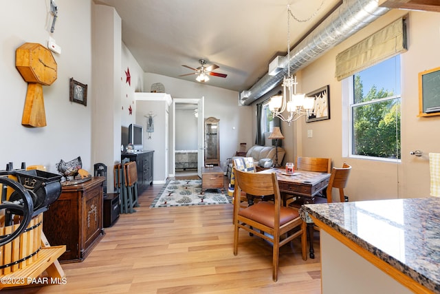 dining space featuring ceiling fan with notable chandelier and light hardwood / wood-style floors