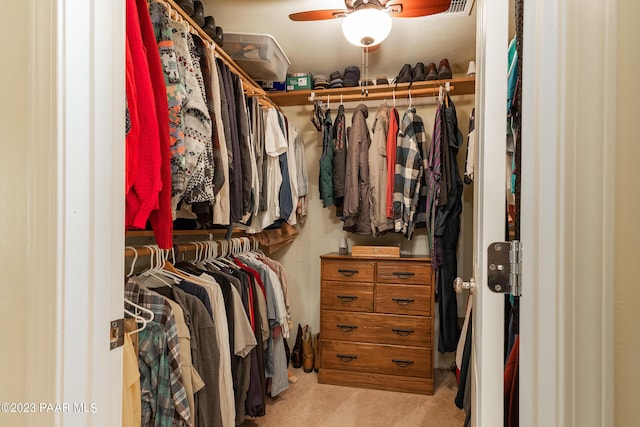 spacious closet with light carpet and ceiling fan