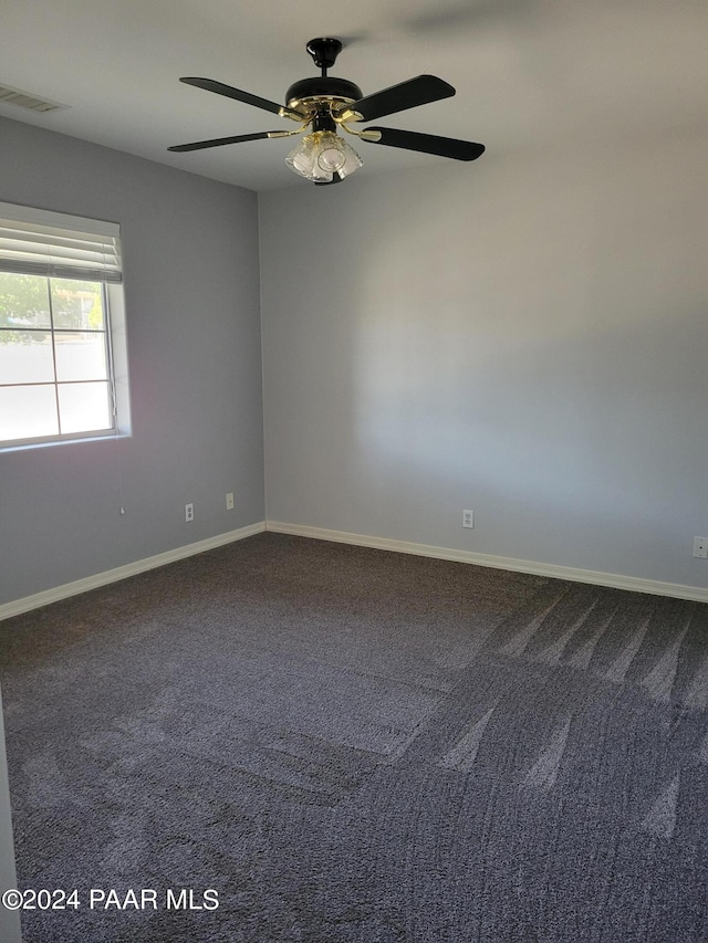 carpeted spare room with ceiling fan