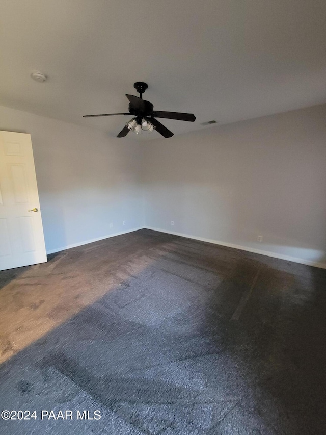 carpeted spare room featuring ceiling fan