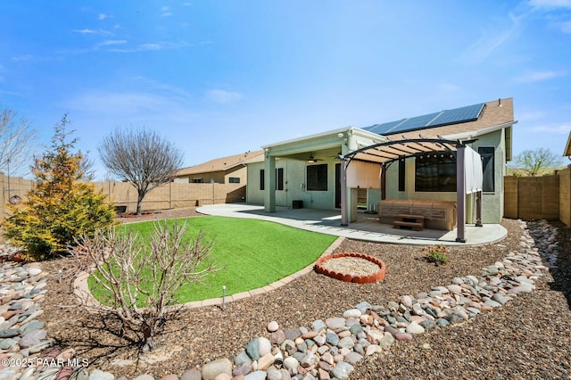 3824 N Wakefield Dr, Prescott Valley, AZ 86314 - back of property with solar panels, a patio area, ceiling fan, stucco siding, and a pergola