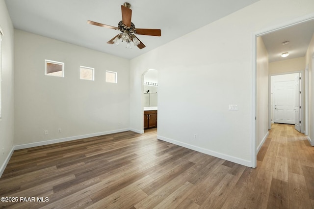 3824 N Wakefield Dr, Prescott Valley, AZ 86314 - spare room featuring arched walkways, ceiling fan, light wood-type flooring, and baseboards
