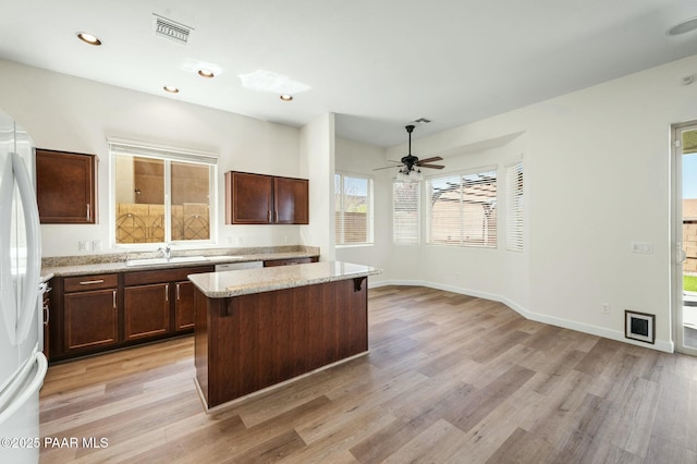 3824 N Wakefield Dr, Prescott Valley, AZ 86314 - kitchen featuring light wood-style flooring, a kitchen island, freestanding refrigerator, a sink, and recessed lighting