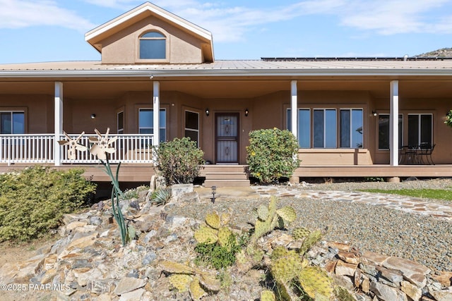 9520 Poland Rd, Mayer, AZ 86333 - country-style home featuring stucco siding, metal roof, and covered porch