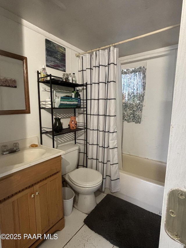 full bathroom with shower / tub combo with curtain, vanity, tile patterned flooring, and toilet