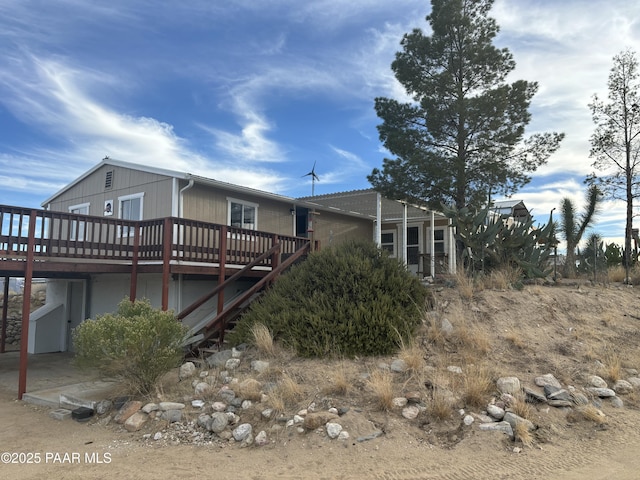 view of property exterior with a wooden deck