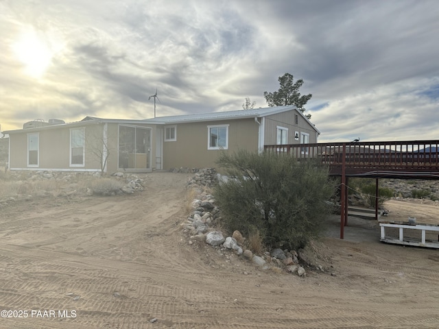 back of property with a wooden deck