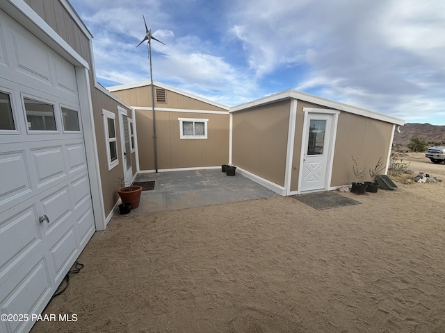 exterior space with a garage and a mountain view