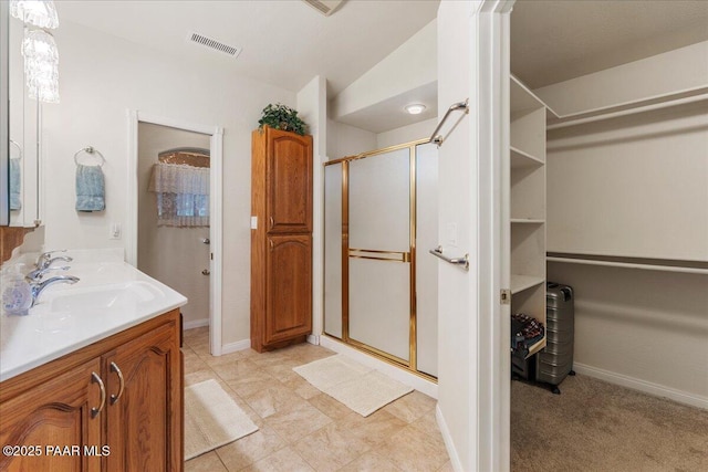 977 Kristin St, Chino Valley, AZ 86323 - bathroom with a shower stall, a walk in closet, and double vanity