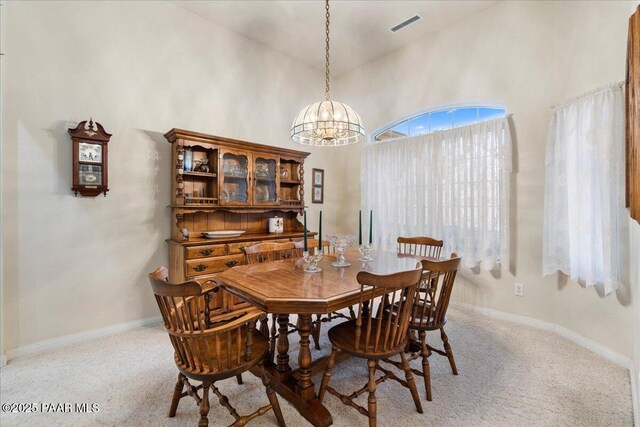 977 Kristin St, Chino Valley, AZ 86323 - dining area featuring a chandelier, a high ceiling, and light colored carpet