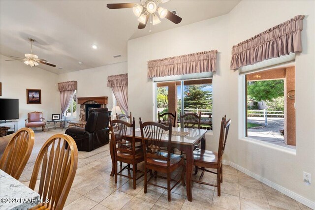 977 Kristin St, Chino Valley, AZ 86323 - dining room with ceiling fan, lofted ceiling, light tile patterned floors, a fireplace with raised hearth, and recessed lighting