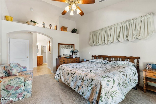 977 Kristin St, Chino Valley, AZ 86323 - bedroom with light carpet, arched walkways, high vaulted ceiling, light tile patterned floors, and ceiling fan