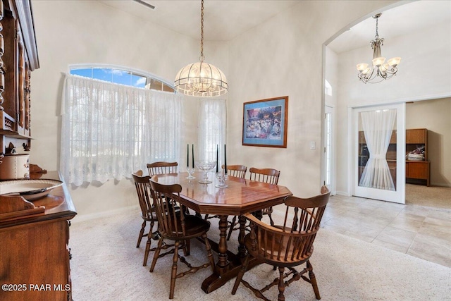 977 Kristin St, Chino Valley, AZ 86323 - carpeted dining room with a chandelier, a towering ceiling, and arched walkways