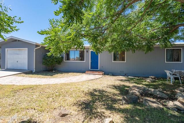 view of front of property featuring crawl space, a front yard, concrete driveway, and an attached garage