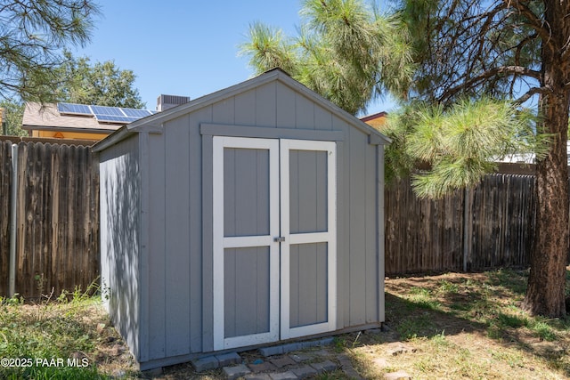 view of shed featuring fence