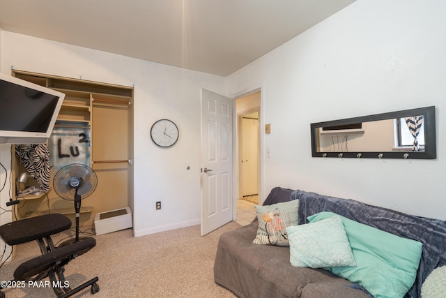 carpeted living area featuring baseboards