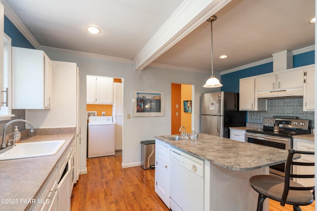 kitchen with under cabinet range hood, an island with sink, appliances with stainless steel finishes, white cabinetry, and a sink