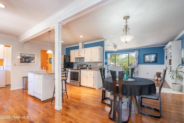 kitchen with washer / dryer, stainless steel range with electric cooktop, white cabinets, dishwasher, and light wood-type flooring