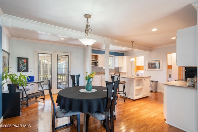 dining space with recessed lighting, ornamental molding, and light wood finished floors