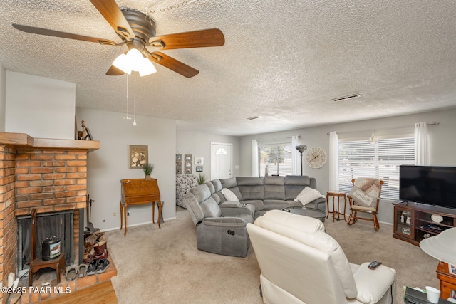 11009 E Lariat Ln, Dewey-Humboldt, AZ 86327 - living area with a ceiling fan, a textured ceiling, a fireplace, and carpet