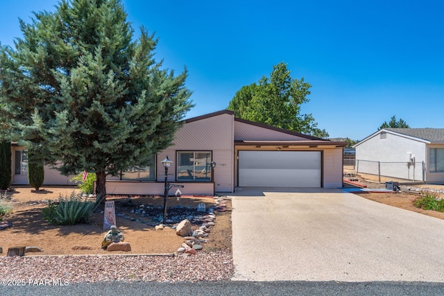 11009 E Lariat Ln, Dewey-Humboldt, AZ 86327 - view of front of house with driveway, a garage, and a metal roof