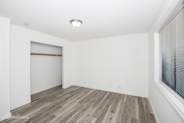 3924 N Taylor Dr, Prescott Valley, AZ 86314 - unfurnished bedroom featuring wood finished floors, a closet, and a textured ceiling