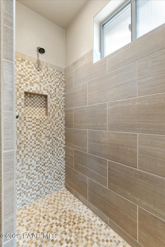 bathroom with a tile shower