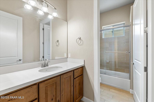bathroom with shower / bath combination with glass door, vanity, and wood finished floors